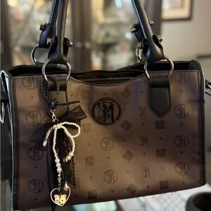 Pretty like new Steve Madden medium shoulder bag monogramed with bag charm !